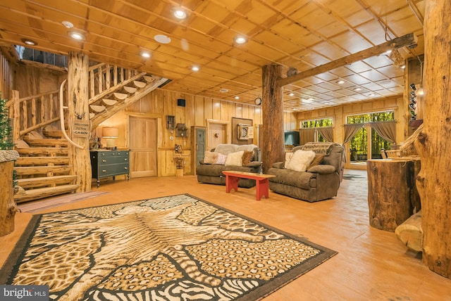 living room with wood walls and hardwood / wood-style floors