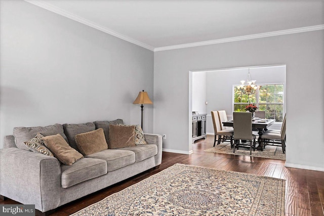 living room with crown molding, a chandelier, and dark hardwood / wood-style flooring