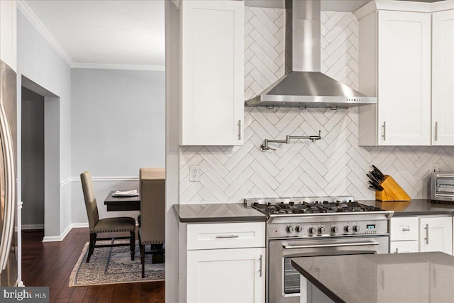 kitchen with high end range, white cabinetry, wall chimney range hood, and dark hardwood / wood-style flooring