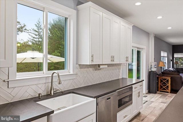 kitchen featuring sink, appliances with stainless steel finishes, a healthy amount of sunlight, and white cabinets