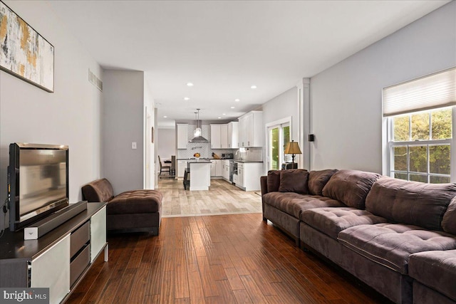 living room with light hardwood / wood-style flooring and plenty of natural light