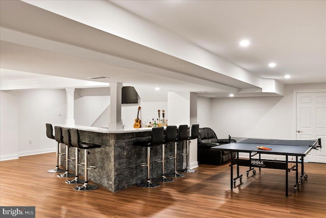 bar featuring hardwood / wood-style flooring