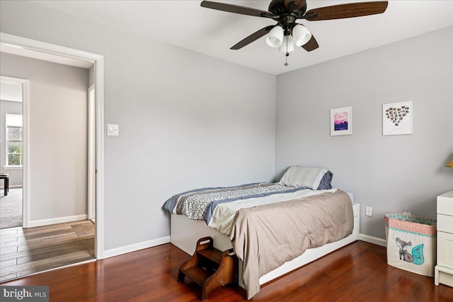 bedroom with ceiling fan and dark hardwood / wood-style flooring