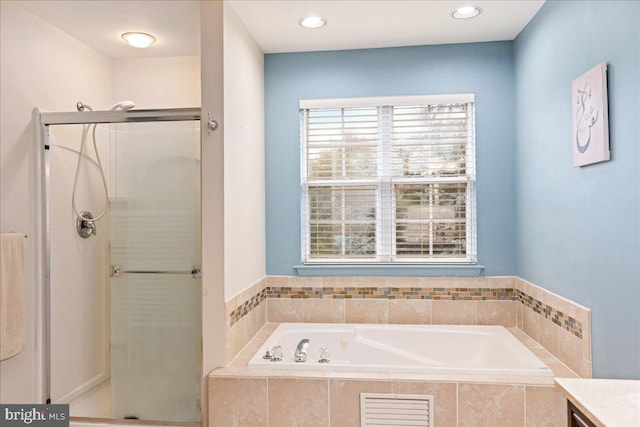 bathroom featuring vanity and independent shower and bath