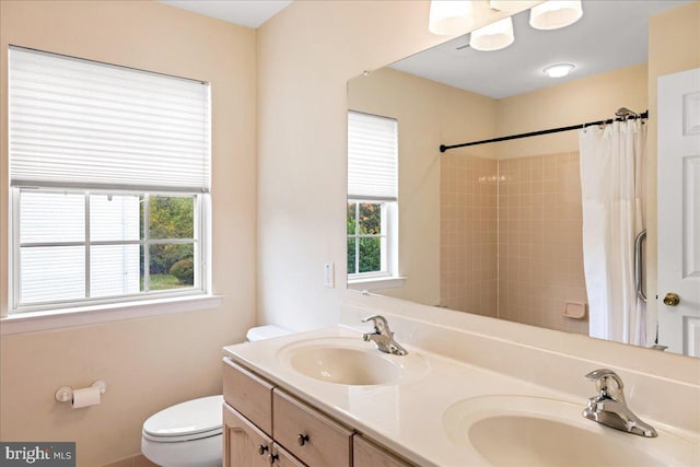 bathroom featuring toilet, a shower with curtain, and vanity