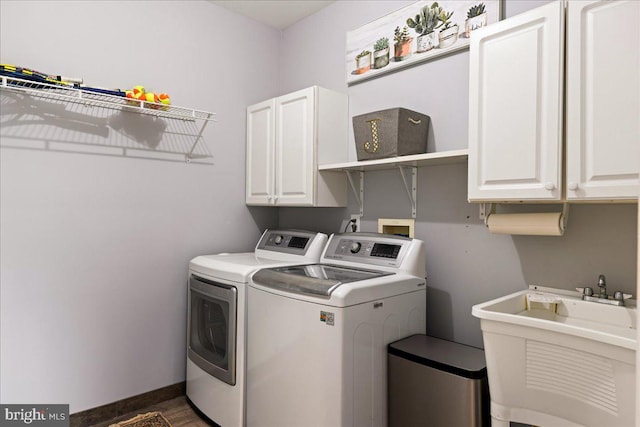 washroom with cabinets, independent washer and dryer, sink, and dark wood-type flooring