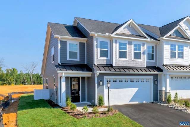 view of front of property with a garage and a front lawn