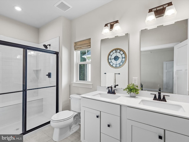 bathroom featuring vanity, tile patterned flooring, toilet, and an enclosed shower