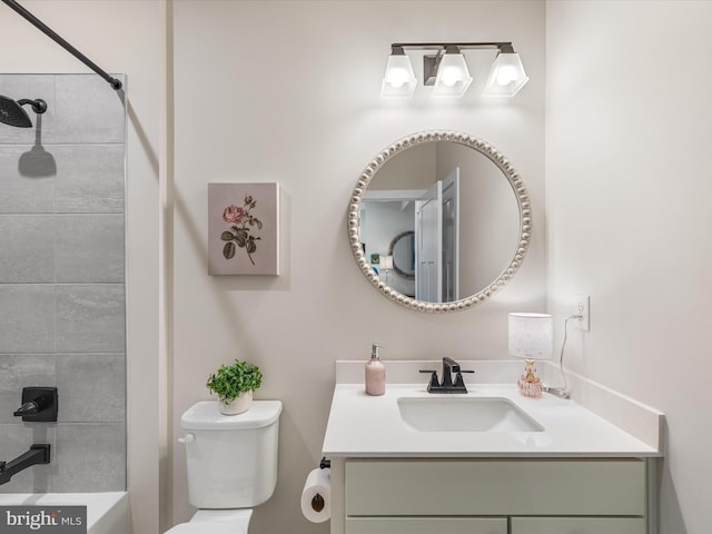 full bathroom with tiled shower / bath combo, vanity, and toilet