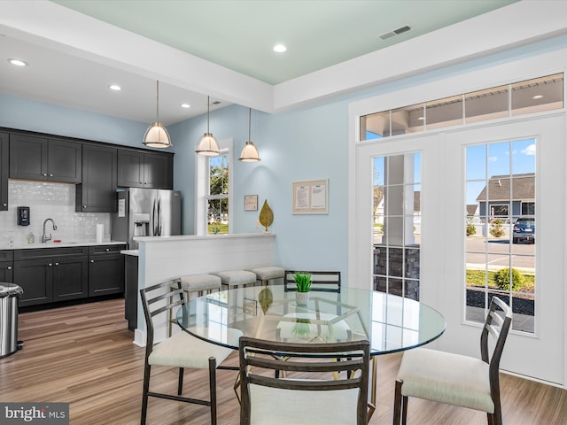 dining space featuring dark wood-type flooring and sink