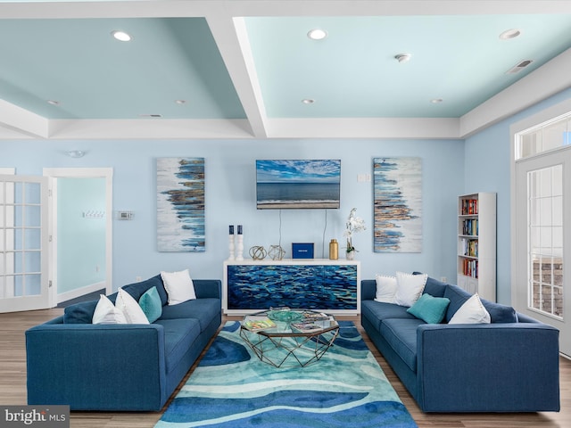 living room with beamed ceiling and hardwood / wood-style flooring