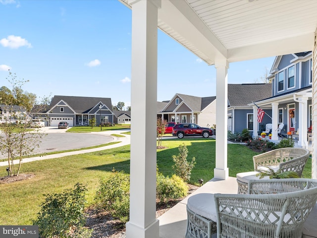 view of patio featuring covered porch and a garage