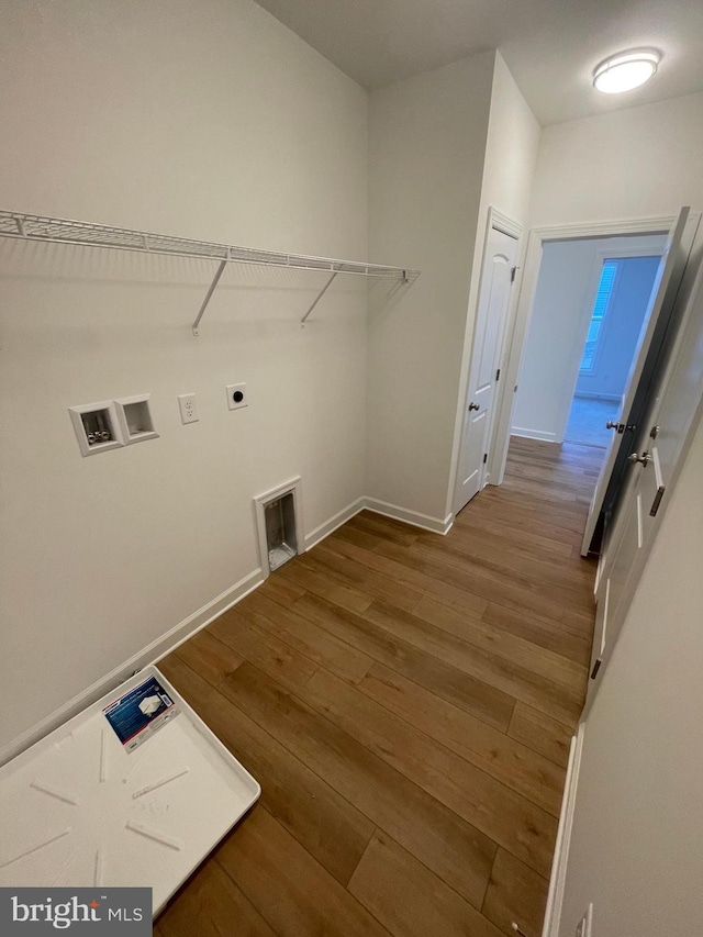 laundry area featuring hookup for a washing machine, baseboards, electric dryer hookup, and wood finished floors