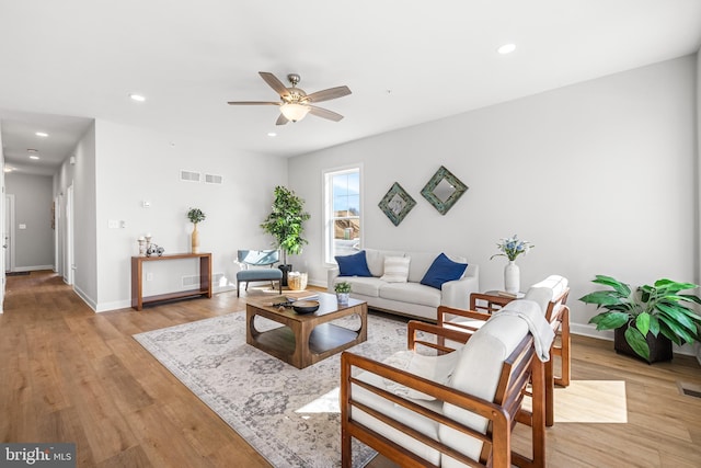 living room featuring recessed lighting, visible vents, light wood-style floors, a ceiling fan, and baseboards