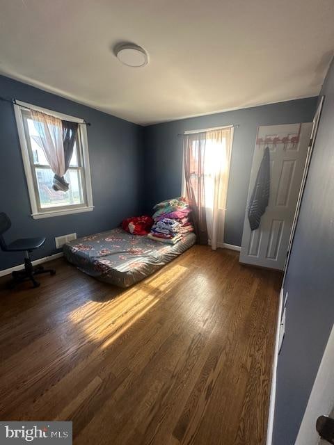 unfurnished bedroom with hardwood / wood-style flooring