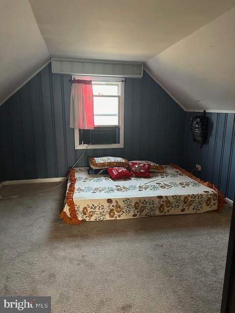 bonus room with carpet floors and vaulted ceiling