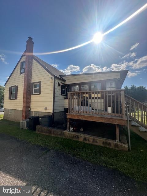 rear view of property featuring a deck