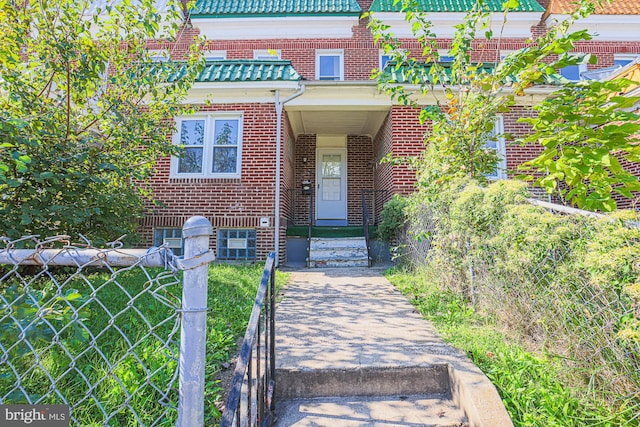 doorway to property featuring a lawn