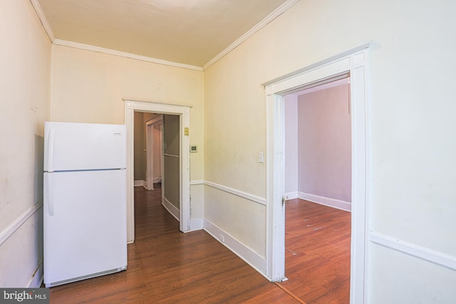 hall featuring ornamental molding and dark hardwood / wood-style flooring