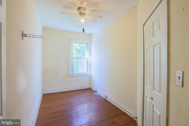 spare room featuring dark wood-type flooring and ceiling fan