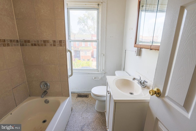 bathroom featuring a bathing tub, toilet, vanity, and plenty of natural light