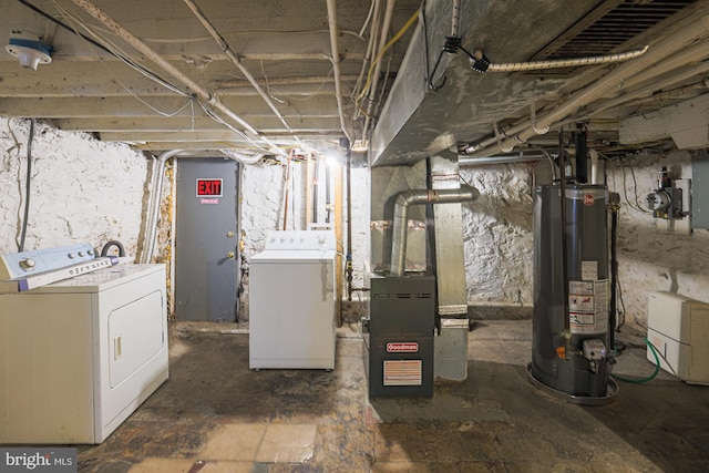 basement with heating unit, washing machine and dryer, and gas water heater