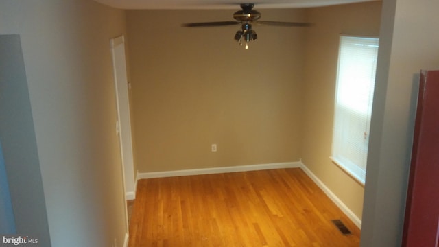 unfurnished room featuring a wealth of natural light, light hardwood / wood-style floors, and ceiling fan