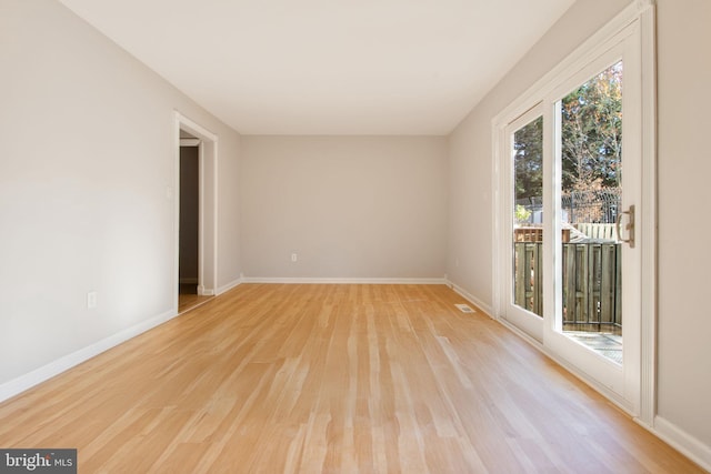 unfurnished room with light wood-type flooring