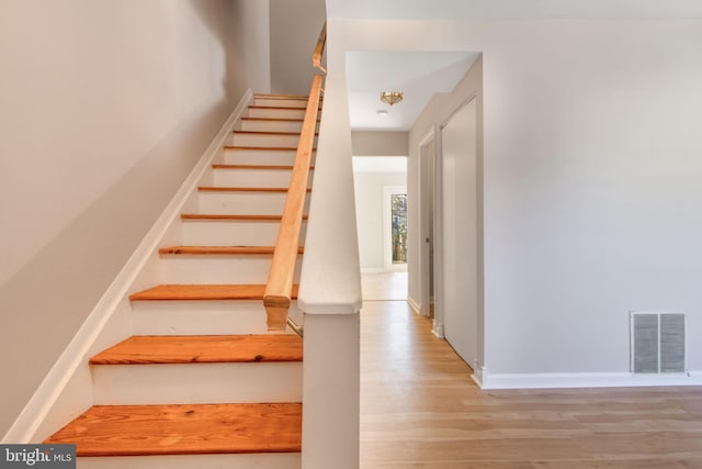 stairs with wood-type flooring