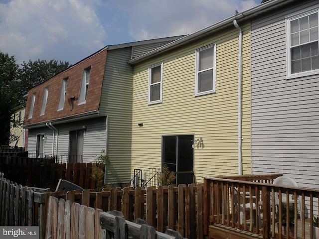 rear view of house featuring a deck