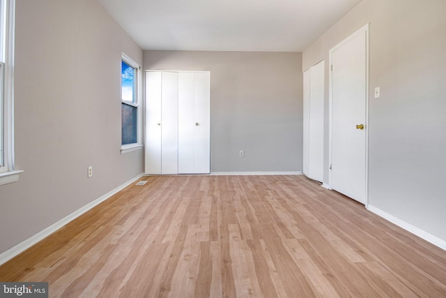 unfurnished bedroom with light wood-type flooring