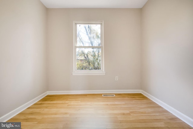 empty room with light hardwood / wood-style flooring