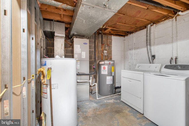 basement with electric water heater, water heater, and washer and clothes dryer