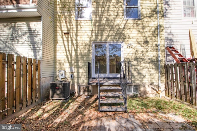 rear view of house featuring cooling unit