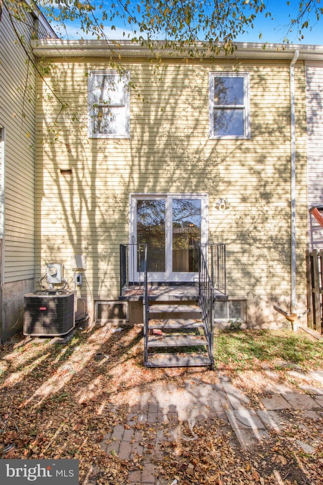 rear view of property with central AC unit