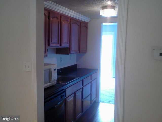 kitchen with dishwasher, hardwood / wood-style floors, and a textured ceiling