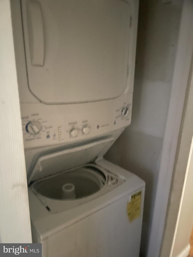 laundry room with stacked washer / dryer