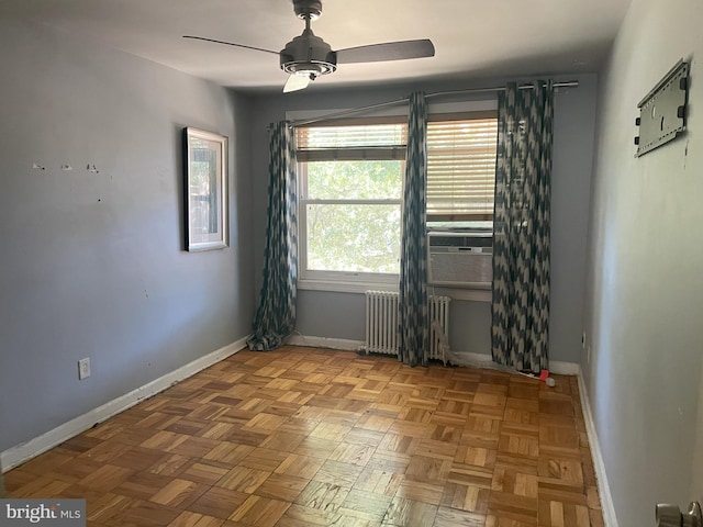 unfurnished room with light parquet flooring, radiator heating unit, cooling unit, and ceiling fan