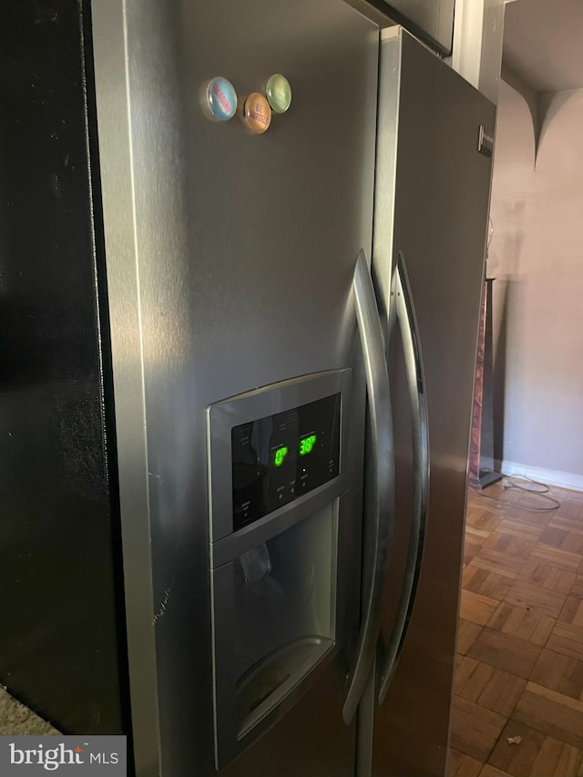 room details with dark parquet floors and stainless steel fridge with ice dispenser