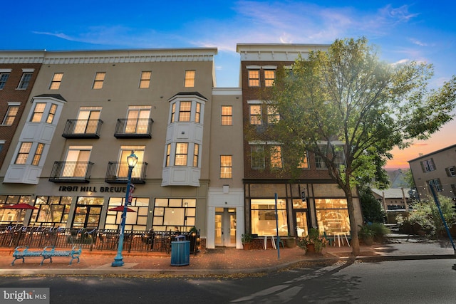 view of outdoor building at dusk