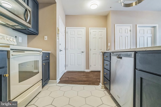 kitchen featuring appliances with stainless steel finishes and light hardwood / wood-style flooring