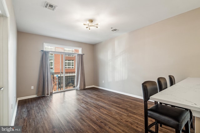 office space with a chandelier and dark hardwood / wood-style flooring