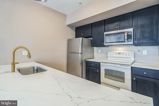 kitchen featuring appliances with stainless steel finishes, sink, and light stone counters