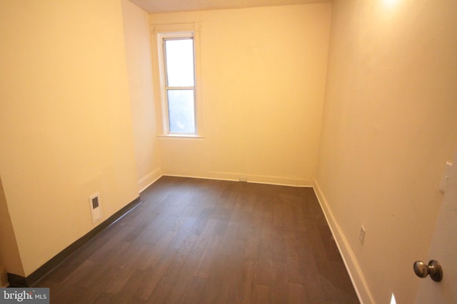 unfurnished room with dark hardwood / wood-style floors