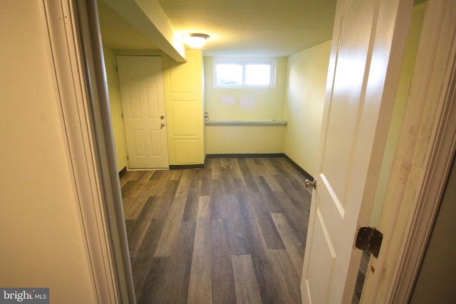 basement with dark hardwood / wood-style floors