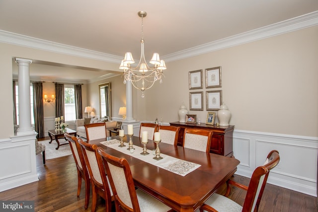 dining space featuring ornamental molding, dark wood-type flooring, a chandelier, and ornate columns