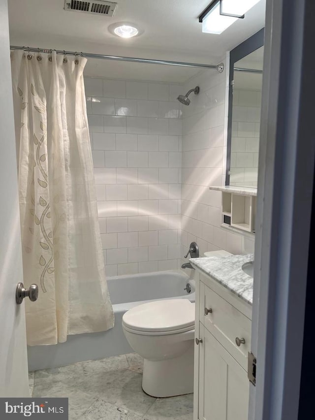 full bathroom with vanity, shower / bath combination with curtain, and toilet