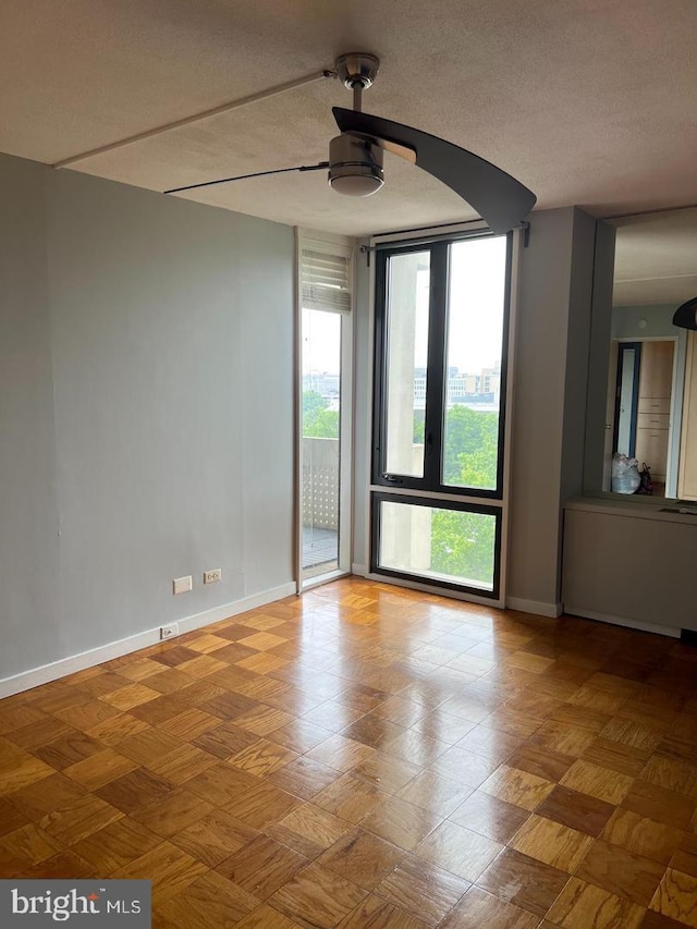 unfurnished room featuring a textured ceiling and ceiling fan