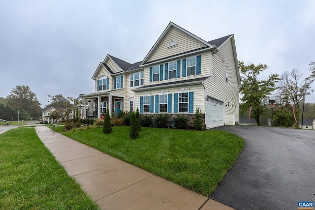 view of front of property with a front lawn and a garage