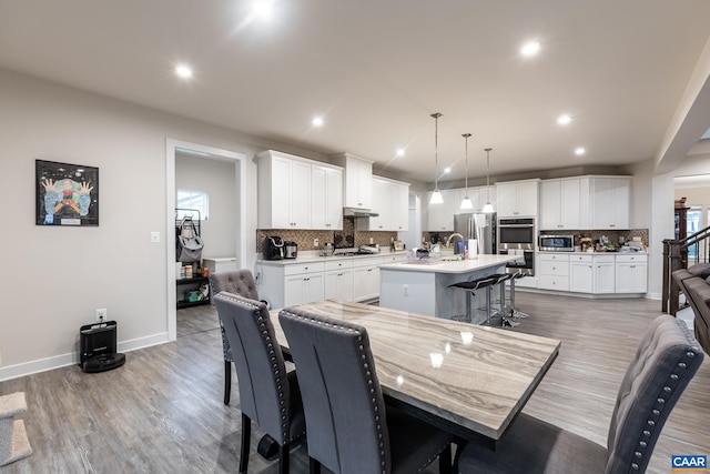 dining space with hardwood / wood-style flooring